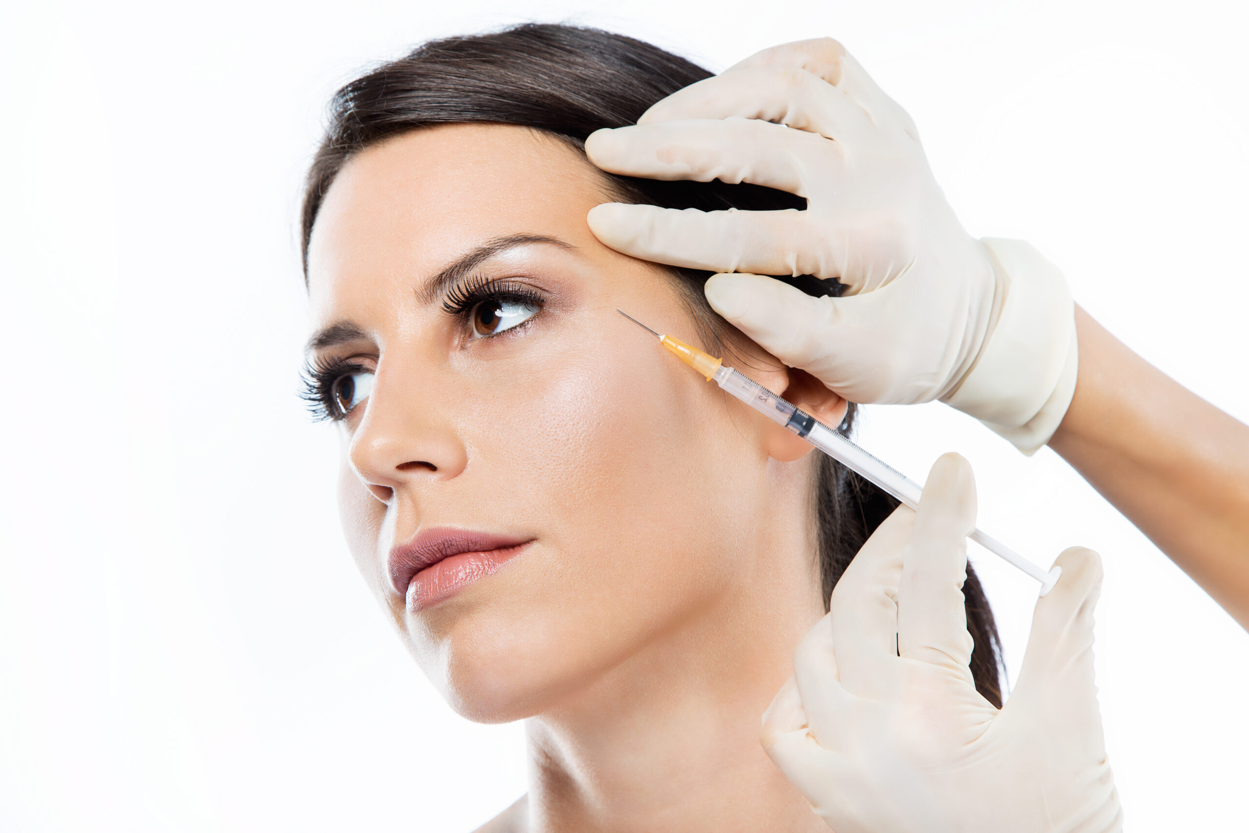 Facial Esthetics; young woman getting botox cosmetic injection in her face